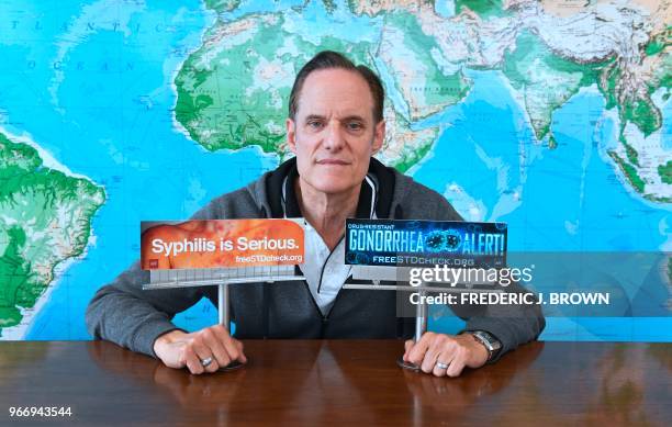 Michael Weinstein, president of the AIDS Healthcare Foundation displays models of billboards which ran in Los Angeles earlier this year but have been...