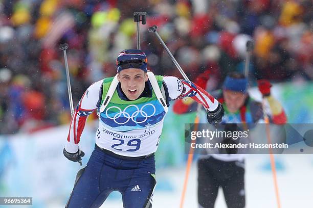 Tim Burke of United States and Michael Greis of Germany competes in the men's biathlon 10 km sprint final on day 3 of the 2010 Winter Olympics at...