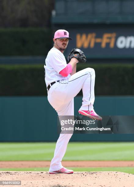 Blaine Hardy of the Detroit Tigers throws a warm-up pitch while wearing a pink hat and shirt to honor Mother's Day during the game against the...