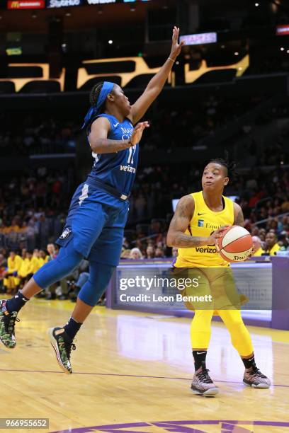 Riquna Williams of the Los Angeles Sparks handles the ball against Alexis Jones of the Minnesota Lynx during a WNBA basketball game at Staples Center...