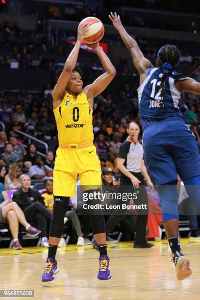Alana Beard of the Los Angeles Sparks handles the ball against Alexis Jones of the Minnesota Lynx during a WNBA basketball game at Staples Center on...