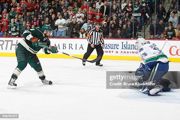 Guillaume Latendresse of the Minnesota Wild has his shot blocked by Andrew Raycroft of the Vancouver Canucks during the game at the Xcel Energy...