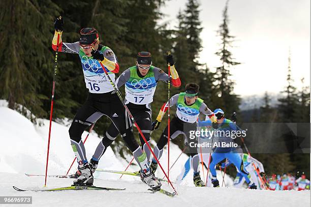 Eric Frenzel, Tino Edelmann and Bjoern Kircheisen of Germany lead apack of athletes during the Nordic Combined Men's Individual 10km on day 3 of the...