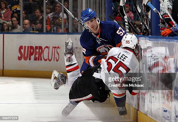 Blake Comeau of the New York Islanders commits a boarding penatly against Brian Lee of the Ottawa Senators on February 14, 2010 at Nassau Coliseum in...