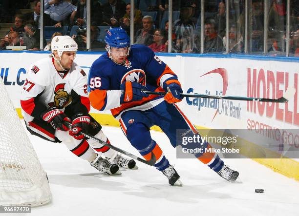 Alex Kovalev of the Ottawa Senators battles for the puck against Dustin Kohn of the New York Islanders on February 14, 2010 at Nassau Coliseum in...