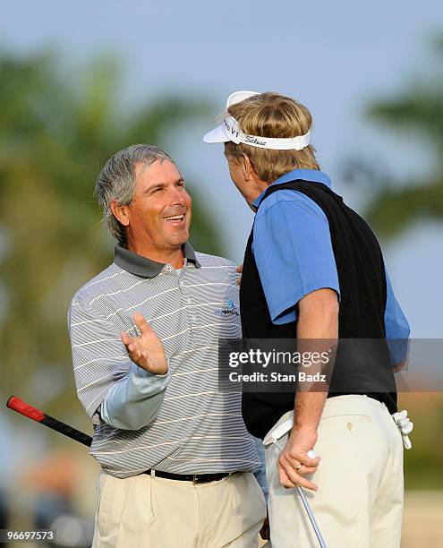 Fred Couples, left, is congratulated by Dan Forsman, right, on his first win on the Champions Tour during the final round of The ACE Group Classic at...