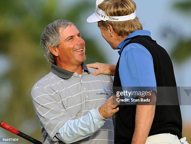 Fred Couples, left, is congratulated by Dan Forsman, right, on his first win on the Champions Tour at the 18th green during the final round of The...