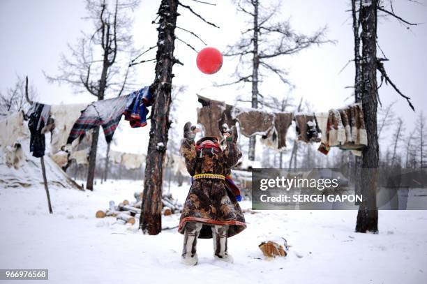 Children of reindeer herders play with a ball on the snow in the remote Yamalo-Nenets region of northern Russia on March 6, 2018.