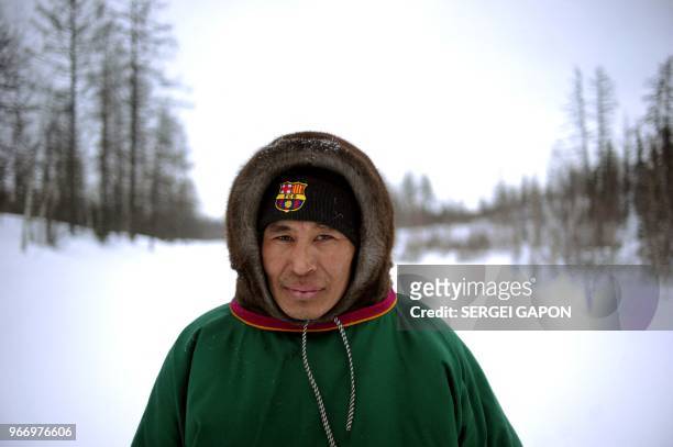 Reindeer herder wearing a cap with the logo of Barcelona's football team poses in the remote Yamalo-Nenets region of northern Russia on March 7, 2018.