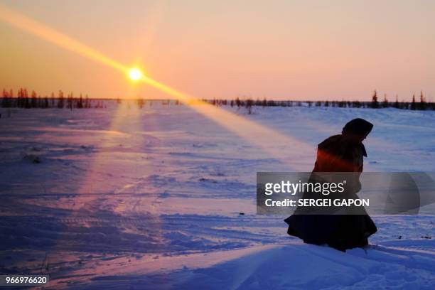 Nenets woman walks on a snow-covered field in the remote Yamalo-Nenets region of northern Russia on March 8, 2018.
