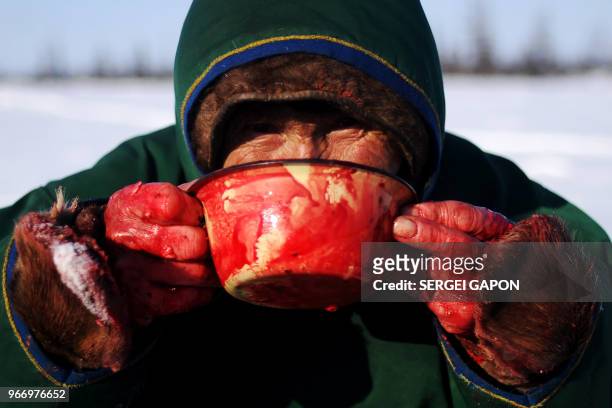 Herder drinks the blood of a reindeer in the remote Yamalo-Nenets region of northern Russia on March 8, 2018.