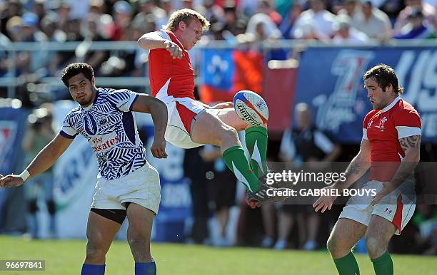 Alafoti Fa'osiliva of Samoa fights for the ball with Jevon Groves and Rhys Shellard of Wales during the 2010 USA Sevens tournament at the Sam Boyd...