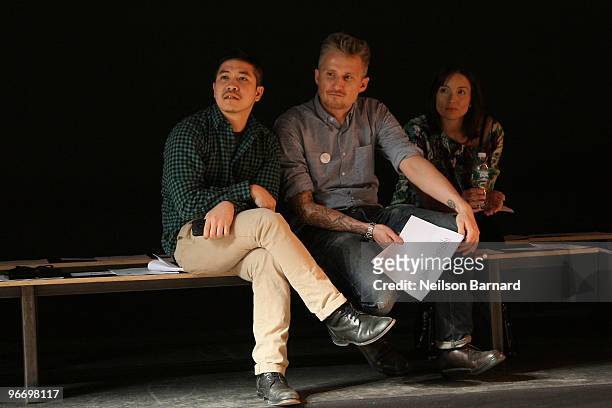 Designer Thakoon and guests watch as a model walks the runway at the Thakoon Fall 2010 Fashion Show during Mercedes-Benz Fashion Week at Eyebeam...