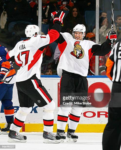 Jason Spezza of the Ottawa Senators is congratulated by teammate Filip Kuba on his third period goal at 9:13 in the game against the New York...