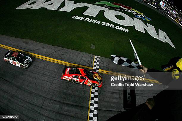 Jamie McMurray, driver of the Bass Pro Shops/Tracker Boats Chevrolet, crosses the finish line to win the the NASCAR Sprint Cup Series Daytona 500...