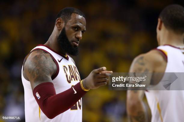 LeBron James of the Cleveland Cavaliers reacts with George Hill against the Golden State Warriors during the third quarter in Game 2 of the 2018 NBA...