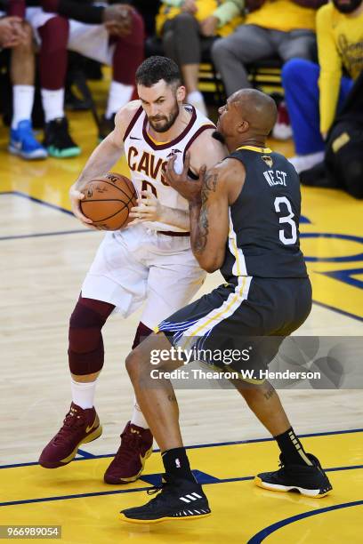 Kevin Love of the Cleveland Cavaliers drives against David West of the Golden State Warriors in Game 2 of the 2018 NBA Finals at ORACLE Arena on June...