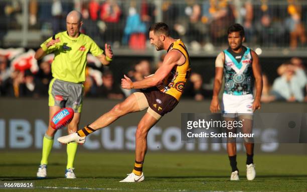 Jack Gunston of the Hawks takes a free kick as the umpire looks on during the round 11 AFL match between the Hawthorn Hawks and the Port Adelaide...