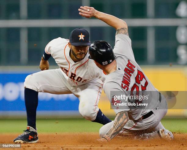 Blake Swihart of the Boston Red Sox is tagged out by Carlos Correa of the Houston Astros attempting to steal second base at Minute Maid Park on June...