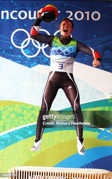 Felix Loch of Germany celebrates winning the gold medal after the final run of the men's luge singles final on day 3 of the 2010 Winter Olympics at...
