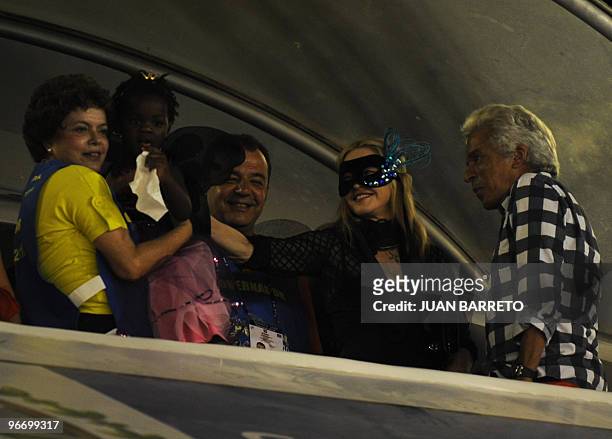 Singer Madonna , accompanied by Brazilian government officials, watches the famed parades of Rio's Carnival in the Sambodrome on February 14, 2010....