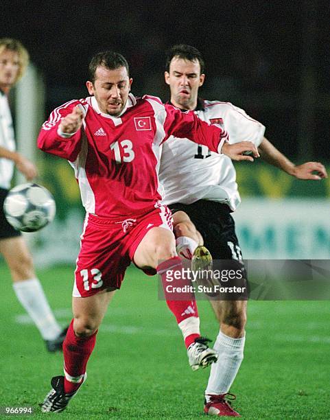 Sergen Yalcin of Turkey is challenged by Austria's Mario Hans during the FIFA 2002 World Cup play-off Second Leg match between Turkey and Austria...
