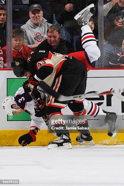 Marc Methot of the Columbus Blue Jackets gets upended by Dustin Byfuglien of the Chicago Blackhawks during the third period on February 14, 2010 at...