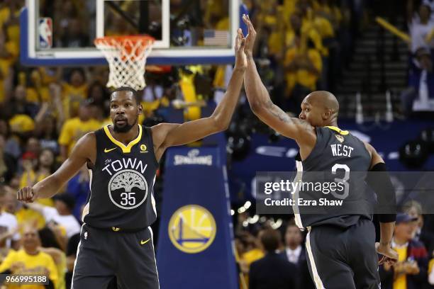 Kevin Durant of the Golden State Warriors celebratres with David West against the Cleveland Cavaliers during the fourth quarter in Game 2 of the 2018...