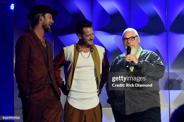 Brian Kelly and Tyler Hubbard, of Florida Georgia Line, present an award to Spotify's John Marks onstage at the Innovation In Music Awards on June 3,...