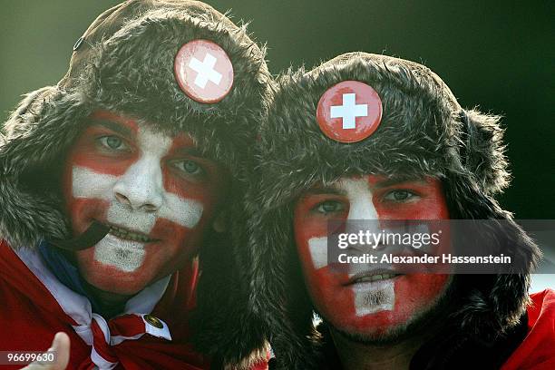 Fans with the Swiss flag painted on their face pose during the finals of the Men's Singles Luge on day 3 of the 2010 Winter Olympics at Whistler...