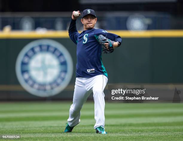 Hisashi Iwakuma of the Seattle Mariners throws a ball around before a game against the Tampa Bay Rays at Safeco Field on June 3, 2018 in Seattle,...