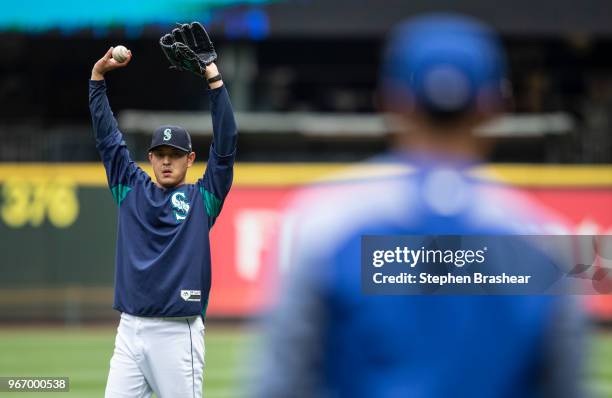Hisashi Iwakuma of the Seattle Mariners throws a ball around before a game against the Tampa Bay Rays at Safeco Field on June 3, 2018 in Seattle,...