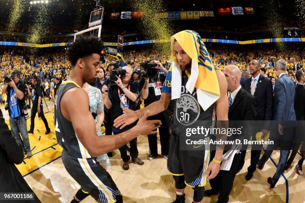 Quinn Cook high fives Stephen Curry of the Golden State Warriors after winning the game against the Cleveland Cavaliers leading the series in Game...