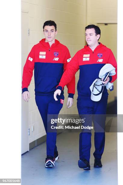 Dejected Jake Lever of the Demons walks out with media manager Matt Goodrope to face a media conference during a Melbourne Demons AFL training...