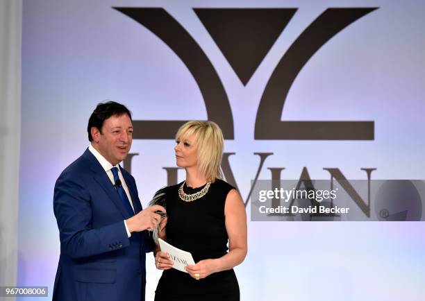 Eddie LeVian and Harper's Bazaar Executive Beauty and Fashion Editor Avril Graham appear on stage during the Le Vian 2019 Red Carpet Revue at the...