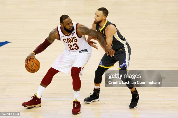 LeBron James of the Cleveland Cavaliers drives against Stephen Curry of the Golden State Warriors in Game 2 of the 2018 NBA Finals at ORACLE Arena on...