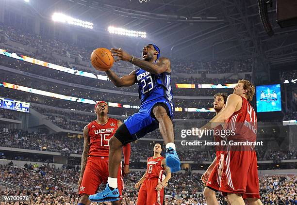 LeBron James of the Eastern Conference goes to the basket against Carmelo Anthony and Dirk Nowitzki of the Western Conference during the NBA All-Star...