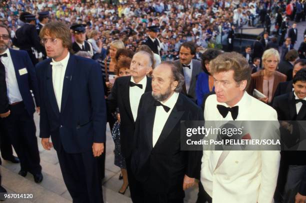 Christophe Lambert, Marco Ferreri et Eddy Mitchell lors de la présentation du film 'l love you' le 13 mai 1986 à Cannes, France.