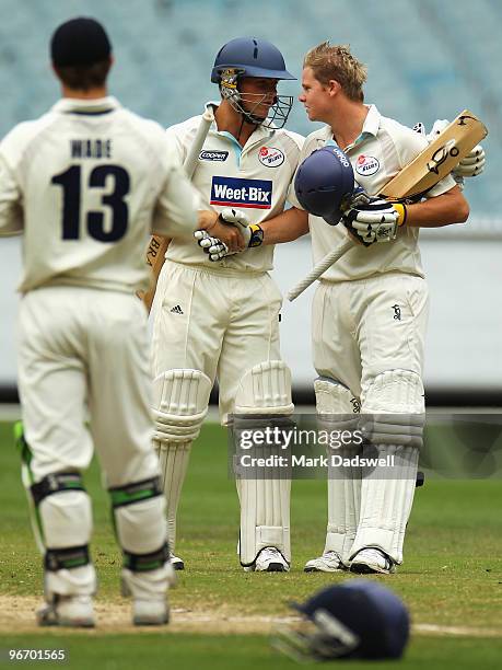 Steven Smith of the Blues celebrates his century with Steve O'Keefe during day four of the Sheffield Shield match between the Victorian Bushrangers...