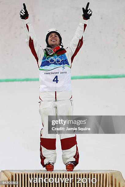 Alexandre Bilodeau of Canada celebrates winning the gold medal during the flower ceremony for the Freestyle Skiing Men's Moguls on day 3 of the 2010...