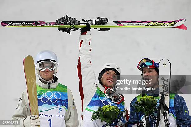 Dale Begg-Smith of Australia celebrates winning silver, Alexandre Bilodeau of Canada gold and Bryon Wilson of United States bronze during the flower...