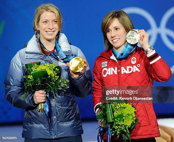 Jennifer Heil of Canada celebrates with her silver medal and Hannah Kearney of United States celebrates with her gold medal during the medal ceremony...