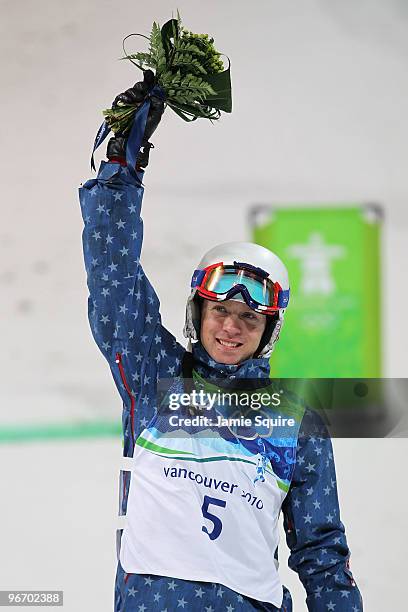 Bryon Wilson of United States celebrates winning bronze during the flower ceremony for the Freestyle Skiing Men's Moguls on day 3 of the 2010 Winter...