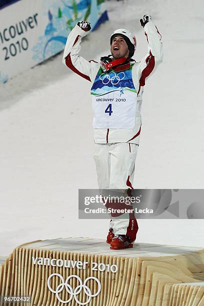 Alexandre Bilodeau of Canada celebrates winning the gold medal during the flower ceremony for the Freestyle Skiing Men's Moguls on day 3 of the 2010...