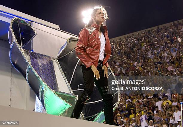 An impersonator of late US singer Michael Jackson performs atop a float of the Unidos da Tijuca samba school at the Sambodrome, during the first...