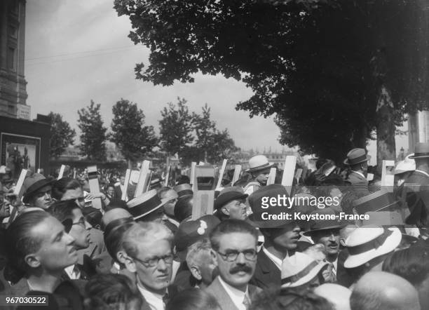 Pour voir le défilé du 14 Juillet, les curieux des derniers rangs utilisent des périscopes, à Paris, France le 14 juillet 1935.