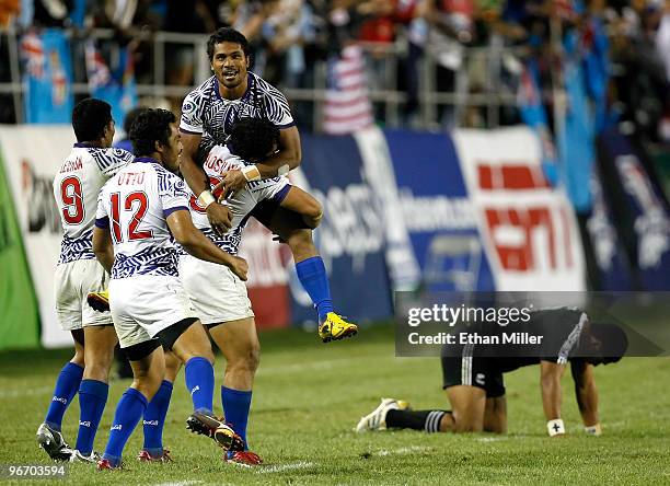 Samoa players Reupena Levasa, Fautua Otto, Alafoti Fa'osiliva and Afa Aiono celebrate in front of Fritz Lee of New Zealand after Samoa's 33-12...