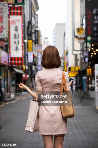 elegant korean woman in the city of seoul downtown - seoul stock pictures, royalty-free photos & images