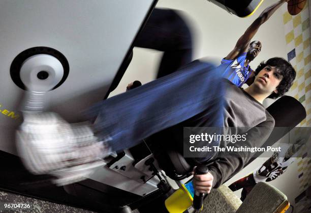 Adam Hammerman works out on a cardio machine in his basement as he deals with his virally caused memory loss with help from his family.