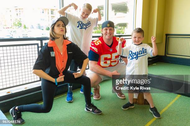 Laura Marano and Jordan Devey pose for a photo with patients from Children's Mercy Hospital while participating in bocce ball at Pinstripes during...